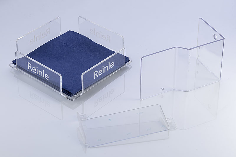 Fräsbiegeteile Acrylglas mit eingraviertem Reinle-Logo